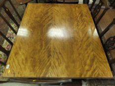 A Victorian satin walnut table, the plain top on turned legs to castors,