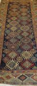 A Shirvan runner, the central diamond shaped medallions in terracotta, green, blue and pale gold,