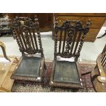 A pair of 19th Century oak framed hall chairs in the Carolean manner,