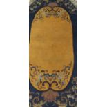 A Chinese rug of oval form,