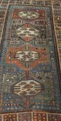 A Kazak rug, the four central lozenges in cream, terracotta, green,