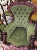 A 19th Century mahogany framed spoon back armchair with scrolling and floral carved arms to