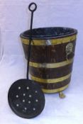 An oak and brass bound fireside bucket and a chestnut roaster