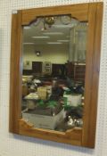 An oak framed rectangular wall mirror with shaped frame (to be sold with the option on lot 211)