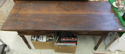 A rectangular teak desk / writing table with kneehole to frieze flanked by two frieze drawers,