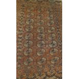 A Bokhara Tekke rug, the central elephant foot medallions in terracotta,