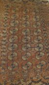 A Bokhara Tekke rug, the central elephant foot medallions in terracotta,