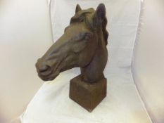 A modern cast iron study of a horse's head on a plinth base