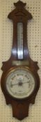 An oak cased aneroid barometer by Douglas Stourbridge bears brass plaque inscribed "Presented to Mr