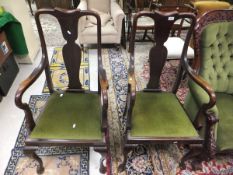A pair of early to mid 20th Century mahogany framed Queen Anne style carver chairs with plain