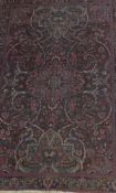 A Persian rug, the central floral medallion in blue, burgundy,