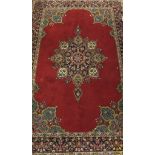 A pair of Kashmir rugs, the central floral decorated medallion in dark blue, gold, sand,