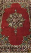 A pair of Kashmir rugs, the central floral decorated medallion in dark blue, gold, sand,