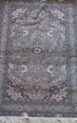 A Persian rug, the central stylised star shaped medallion in pale green, blues, cinnamon,