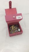 A pink jewellery box containing a collection of costume jewellery to include necklaces, earrings,