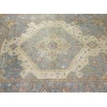 An Indian rug, the central medallion in cream, pale sand, pale blue, pale yellow and pale salmon,