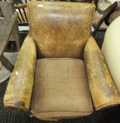 A 1930's armchair upholstered in brown leather,