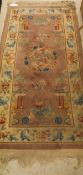 A Chinese superwash rug decorated with birds, flowers and pagodas in pale aubergine, cream, blue,