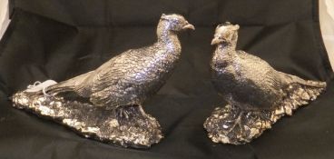 A pair of silver covered pheasant ornaments,