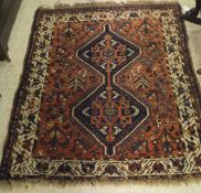 A Shiraz rug, the two central diamond shaped linked medallions in dark blue,
