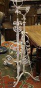 Two Victorian white painted wrought iron adjustable torcheres