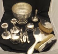 A pair of silver mounted candlesticks, a pair of silver lidded glass dressing table jars,