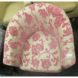 A modern tub armchair upholstered in cream and pink chenille fabric