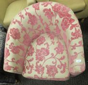 A modern tub armchair upholstered in cream and pink chenille fabric