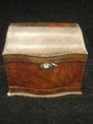 A circa 1900 embossed and gilded leather covered desk top stationery box of serpentine form