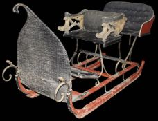 A late 19th Century Continental painted and gilded upholstered sleigh with driver's seat and two