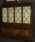 A Portuguese mahogany breakfront display cabinet with swan neck moulded pediment over four astragal