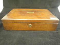 A 19th Century mahogany rectangular lidded box with silk-lined tray liner