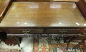 An early 20th Century mahogany dressing table of two short drawers on cabriole legs to brown china