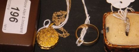 A 9 carat gold circular locket with engraved decoration and with chain,