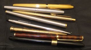 A collection of pens to include a 9 carat gold cased pencil, a Shaeffer fountain pen,