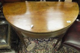 A Victorian mahogany demi lune card table with green baize interior,