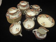 A collection of early 20th Century porcelain tea wares decorated in iron red,