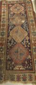 A Caucasian rug, the four central medallions in terracotta,