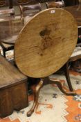 A 19th Century mahogany circular tilt top occasional table raised on turned and ringed column to