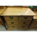 A pine chest of two short and two long drawers, two pine bedside cupboards,