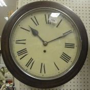 A stained beech framed circular wall clock, the dial with Roman numerals,