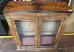 A Victorian walnut two door display cabinet enclosing three shelves,