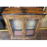 A Victorian walnut two door display cabinet enclosing three shelves,