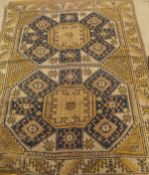 A collection of three rugs to include a Caucasian rug, the two central medallions in mushroom,