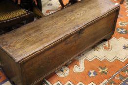 A 19th Century rectangular oak hutch / coffer, the single plank top opening to reveal a candle box,