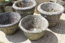 Two pairs of composite stone garden urns,