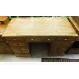 A modern pine pedestal desk, the plain top above three drawers above two banks of three drawers,