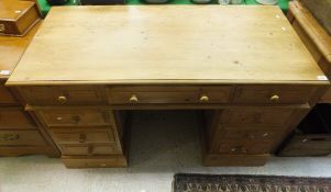 A modern pine pedestal desk, the plain top above three drawers above two banks of three drawers,