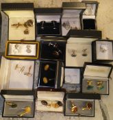 A shoe box containing a large collection of cufflinks,