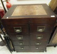 A mahogany banker's type chest of eight drawers with brass lug handles,